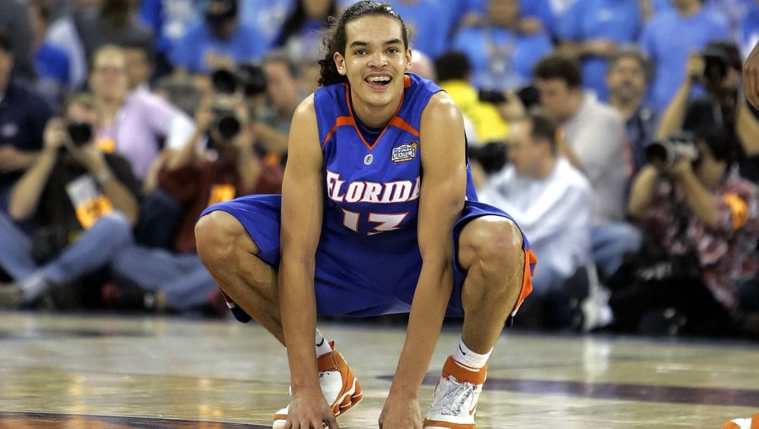 Florida's Joakim Noah smiles as he sits at center court near the end of the the Final Four national championship basketball game.