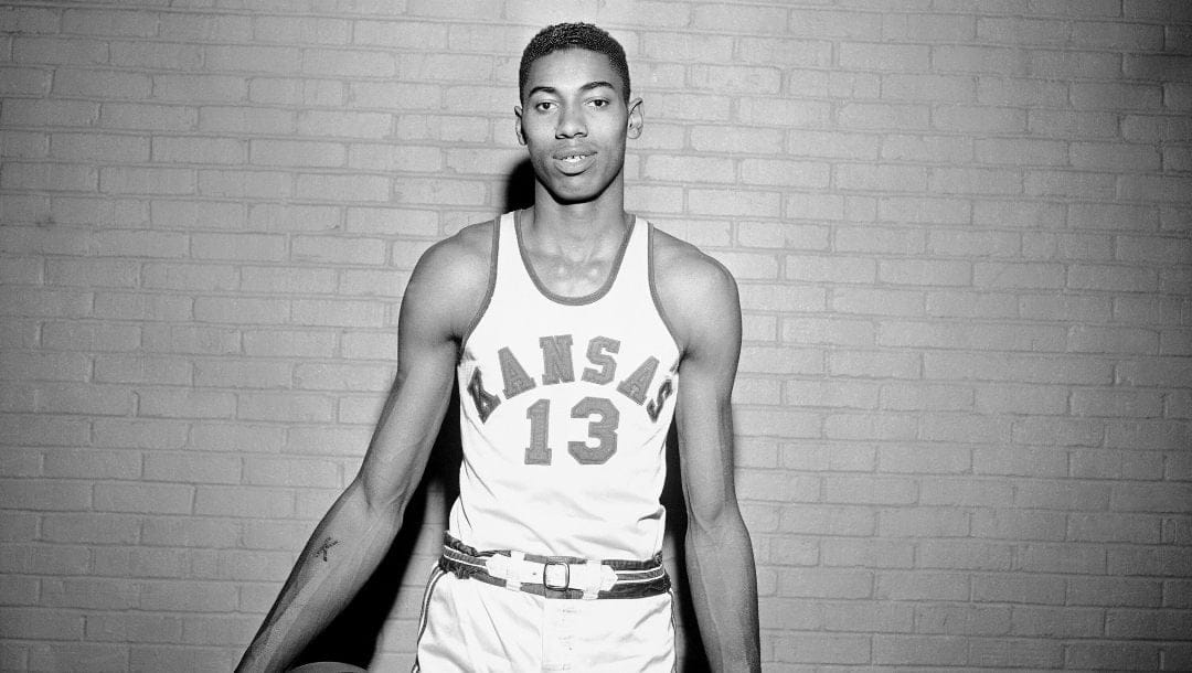 Wilt Chamberlain, Kansas University's lanky 7-foot basketball star, holds ball loosely between arm and hip as he poses for a picture during pause in practice in Allen Field House in Lawrence, Kan., March 1, 1957.