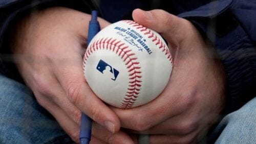 A fan holds a baseball that he hoped to get autographed before a game between the Detroit Tigers and the Chicago White Sox.