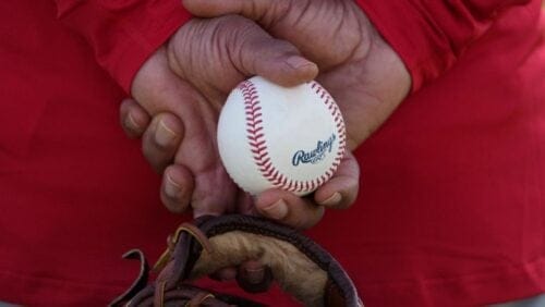 St. Louis Cardinals special instructor and MLB Hall of Fame shortstop Ozzie Smith holds a ball as he watches during a spring training.