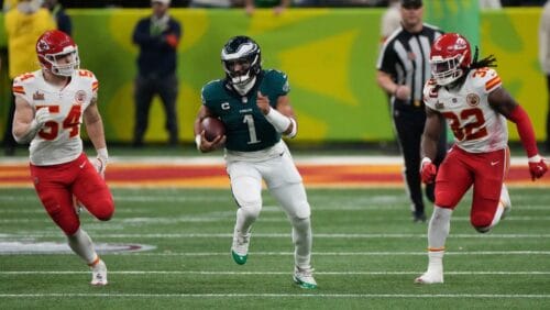 Philadelphia Eagles quarterback Jalen Hurts (1) runs past Kansas City Chiefs linebacker Leo Chenal (54) and linebacker Nick Bolton (32) during the second half of the NFL Super Bowl 59 football game, Sunday, Feb. 9, 2025, in New Orleans.