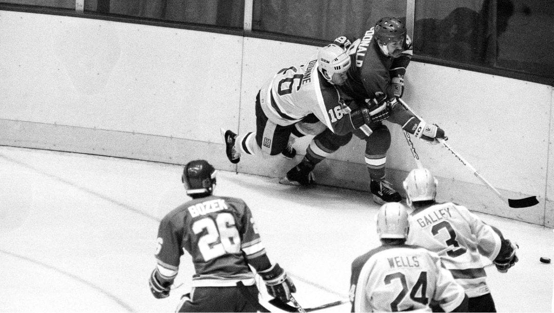 Los Angeles Kings Marcel Dionne (16) battles with Calgary Flames Lanny McDonald for control of the puck during pre-season game.