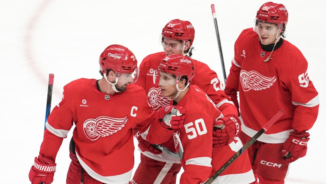 Detroit Red Wings center Dylan Larkin, left, Dominik Shine (50) Albert Johansson (20) and Marco Kasper (92) celebrate after an NHL hockey game against the Los Angeles Kings, Monday, Jan. 27, 2025, in Detroit.