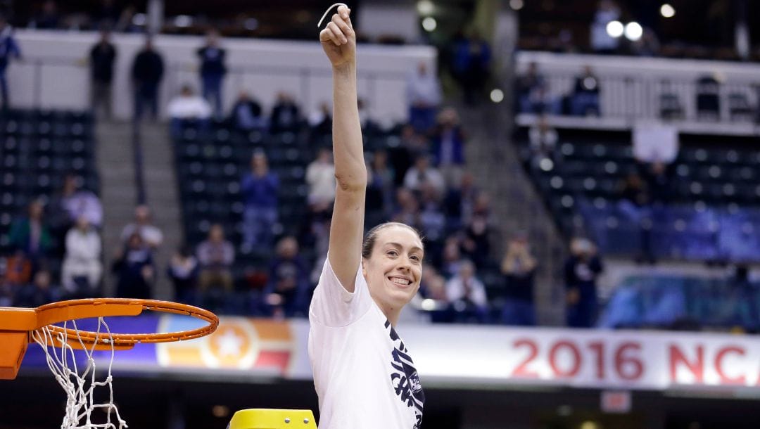 Connecticut's Breanna Stewart (30) celebrates by cutting down the net after Connecticut's 82-51 victory over Syracuse.