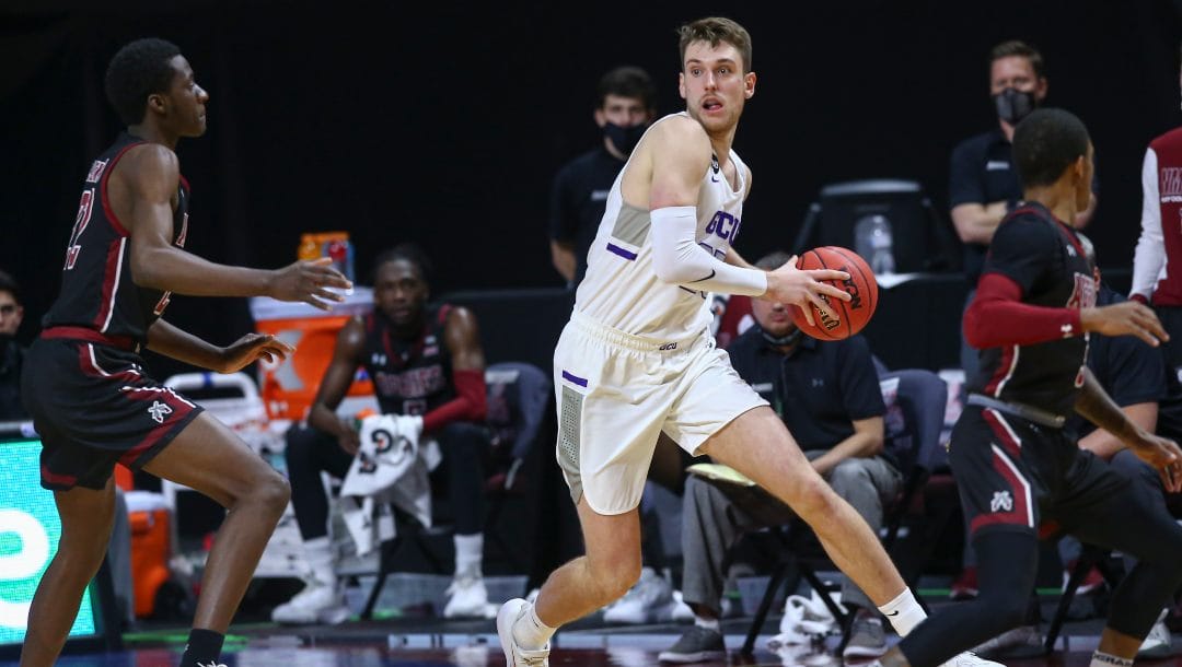 Grand Canyon's Alessandro Lever, right, looks to pass the ball under pressure from New Mexico State's Wilfried Likayi (22) during the first half of an NCAA college basketball game for the championship of the Western Athletic Conference men's tournament Saturday, March 13, 2021, in Las Vegas.