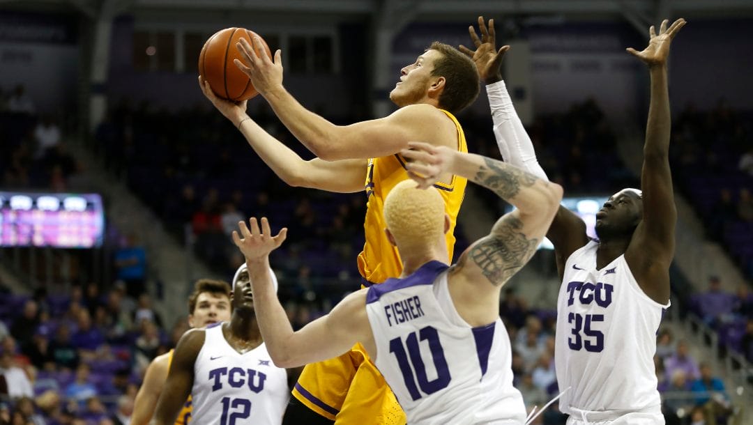 Lipscomb guard Garrison Mathews (24) drives inside past TCU defenders Jaylen Fisher (10), Kouat Noi (12) and Yuat Alok (35) during the first half of an NCAA college basketball game, Tuesday, Nov. 20, 2018, in Fort Worth, Texas.