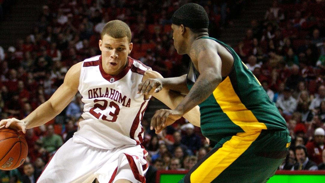 Oklahoma forward Blake Griffin, left, drives to the basket against a Baylor player in the second half of an NCAA college basketball game on Saturday, Jan. 24, 2009 in Norman, Okla. Oklahoma won 95-76.