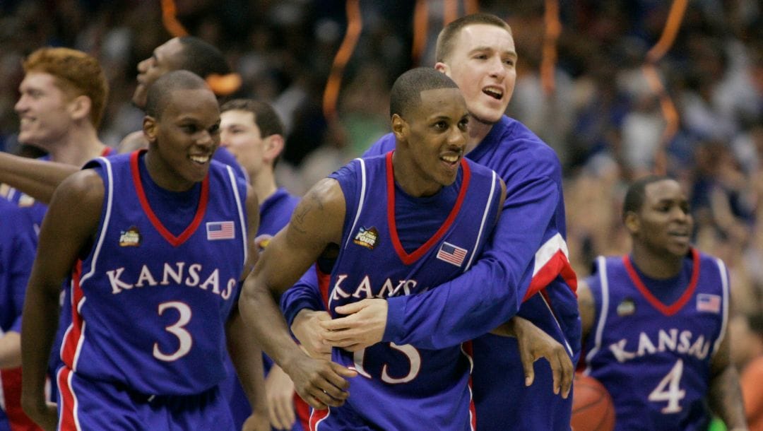 FILE - In this April 7, 2008, file photo, Kansas players Russell Robinson (3), Mario Chalmers (15) Brady Morningstar.