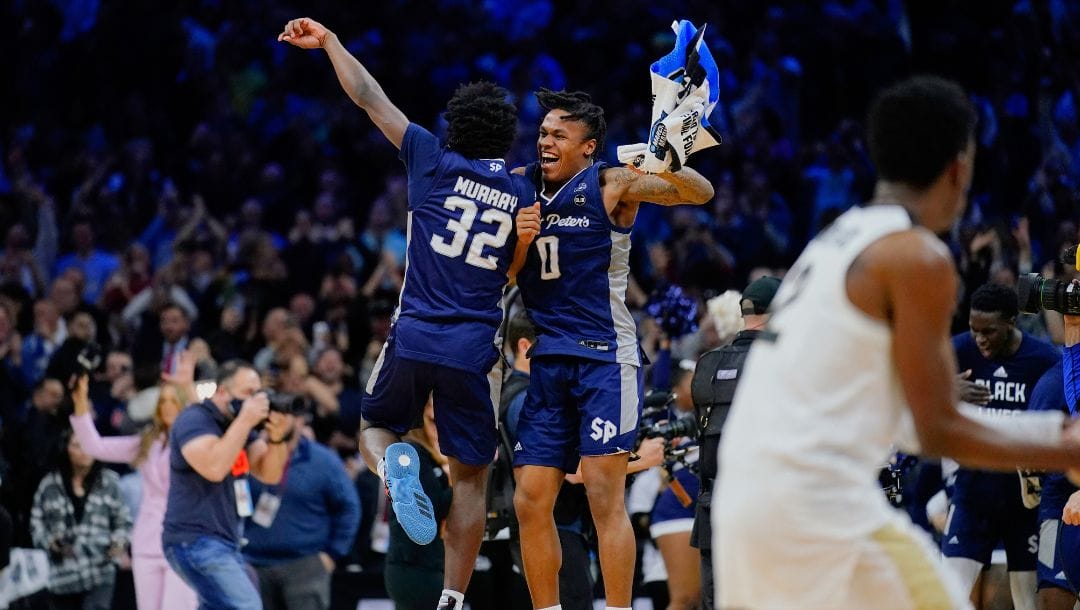 FILE - Saint Peter's Jaylen Murray, left, and Latrell Reid celebrate after their team won a college basketball game.