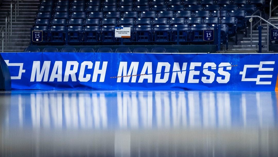 March Madness branding near the court before a first-round college basketball game between Kent State and Notre Dame in the women's NCAA Tournament Saturday March 23, 2024 in South Bend, Ind. The NCAA has presented a plan to Division I conference commissioners that would expand the lucrative men's and women's basketball tournaments by four or eight teams alongside an option to leave each field at 68 teams, according to a person familiar with the details.