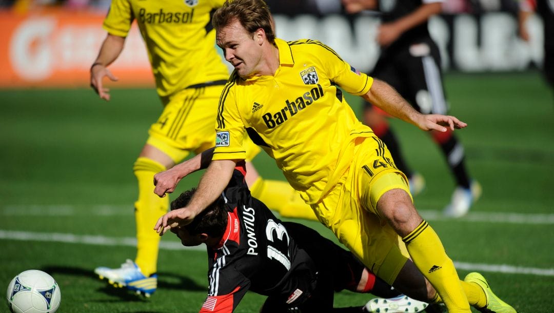 Columbus Crew defender Chad Marshall (14) battles for the ball against D.C. United midfielder/forward Chris Pontius (13).