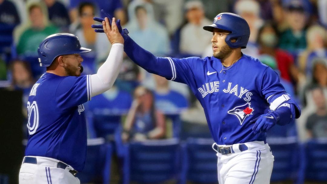 Toronto Blue Jays' George Springer, right, is congratulated by Alejandro Kirk after his two-run home run against the Atlanta.