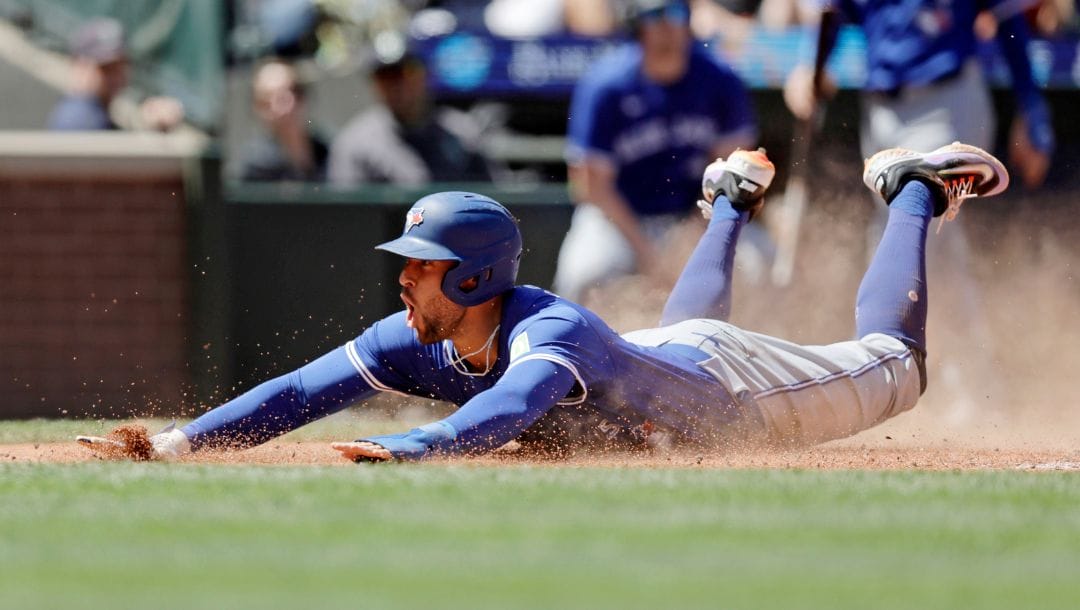Toronto Blue Jays' George Springer yells as he scores during the fifth inning in a baseball game against the Seattle Mariner.