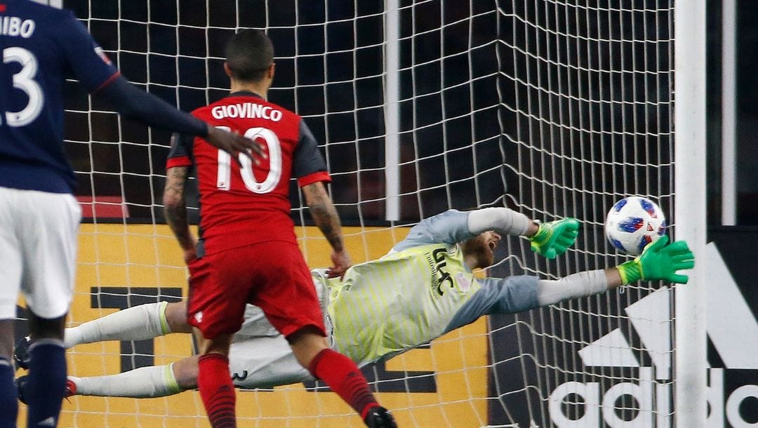 Toronto FC's Sebastian Giovinco (10) scores on a penalty kick against New England Revolution goalie Matt Turner.