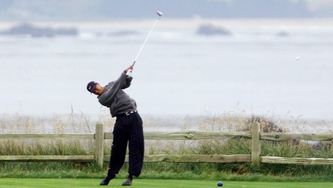 Tiger Woods, of Windermere, Fla., hits his third shot from the tee after his first went into the ocean on the 18th hole during the completion of the second round of the 100th U.S. Open Golf Championship at the Pebble Beach Golf Links in Pebble Beach, Calif., Saturday, June 17, 2000.