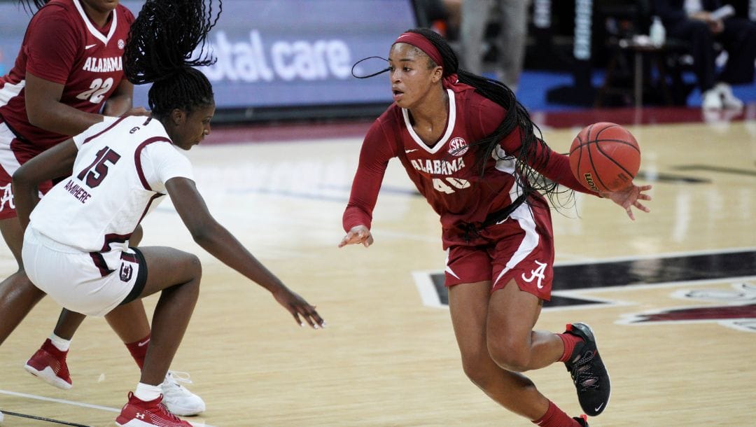 FILE - In this Jan. 31, 2021, file photo, Alabama forward Jasmine Walker (40) is defended by South Carolina forward.