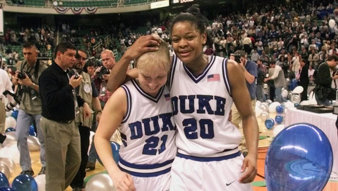 Duke's Alana Beard (20) celebrates with teammate Krista Gingrich (21) Duke's 87-80 win in the ACC Women's Basketball championship.
