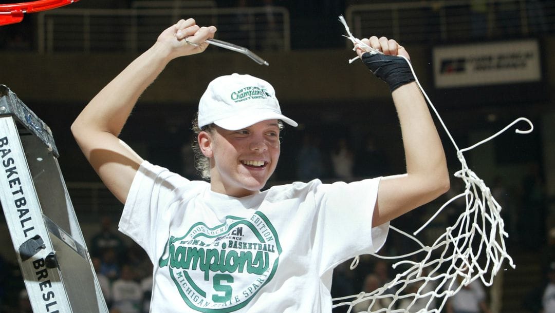 Michigan State's Kristin Haynie cuts down the net following a 77-34 win over Michigan Wednesday, Feb. 23, 2005, in East Lansing.