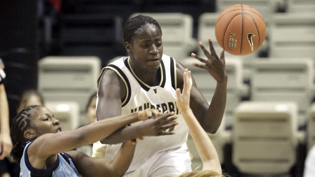 Vanderbilt forward Carla Thomas, center, fights for the ball with Rhode Island's Tanya Rhodes, left, and Katie Stailing (23) in the second half on Friday, Nov. 26, 2004 in Nashville, Tenn.