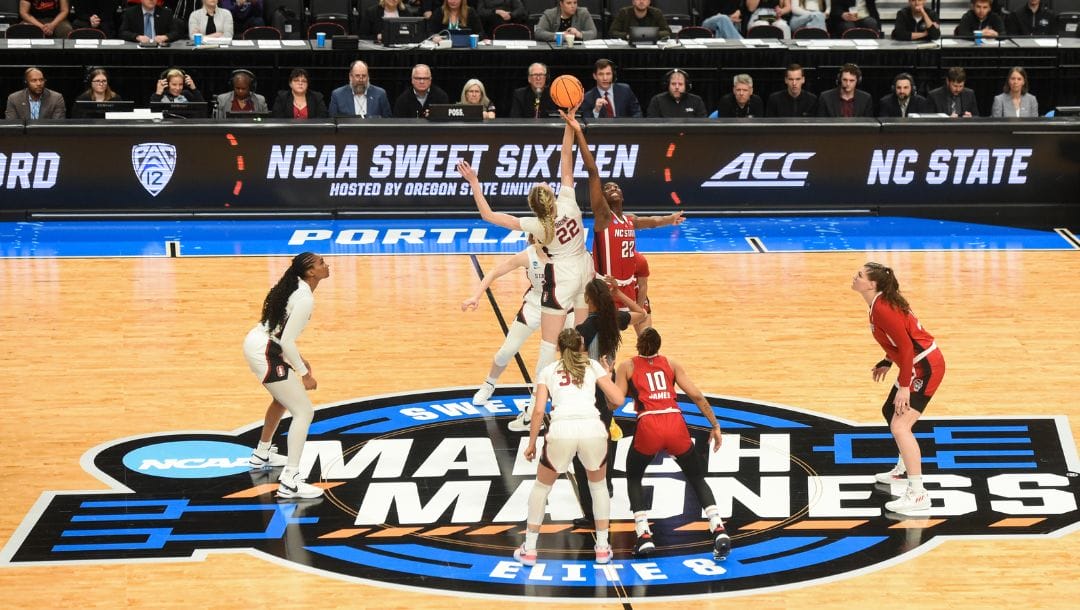 FILE - Stanford forward Cameron Brink and North Carloina State guard Saniya Rivers try to get the ball during a tip-off.