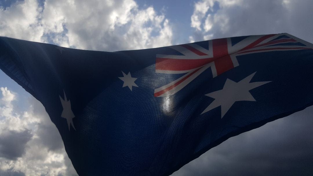 Flag of Australia with clouds