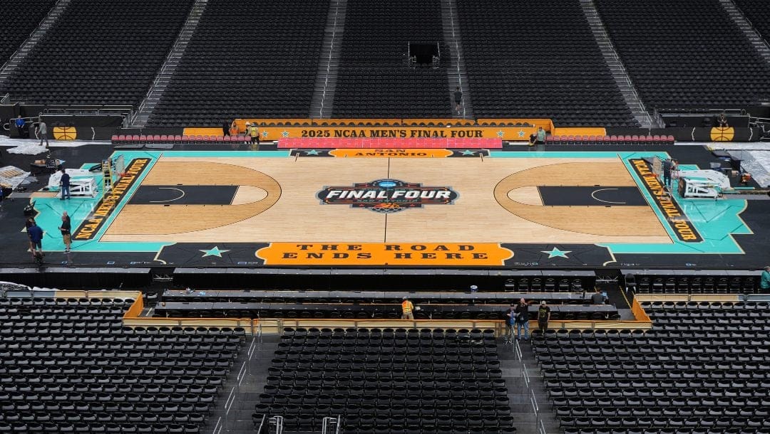 Workers make final preparations around the Men's NCAA Final Four college basketball court at the Alamodome, Monday, March 31, 2025, in San Antonio.
