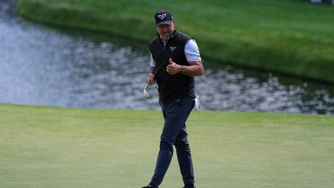 Phil Mickelson waves after making a putt on the 16th hole during the first round at the Masters golf tournament, Thursday, April 10, 2025, in Augusta, Ga.