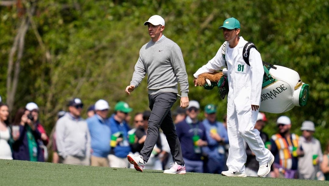 Rory McIlroy, of Northern Ireland, walks with caddie Harry Diamond on the fifth hole during a practice around at the Masters golf tournament, Wednesday, April 9, 2025, in Augusta, Ga.