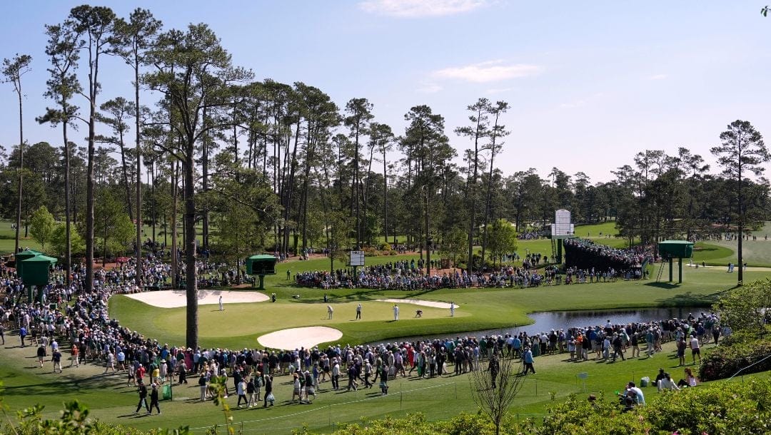 Golfers putt on the 16th hole during a practice around at the Masters golf tournament, Wednesday, April 9, 2025, in Augusta, Ga.