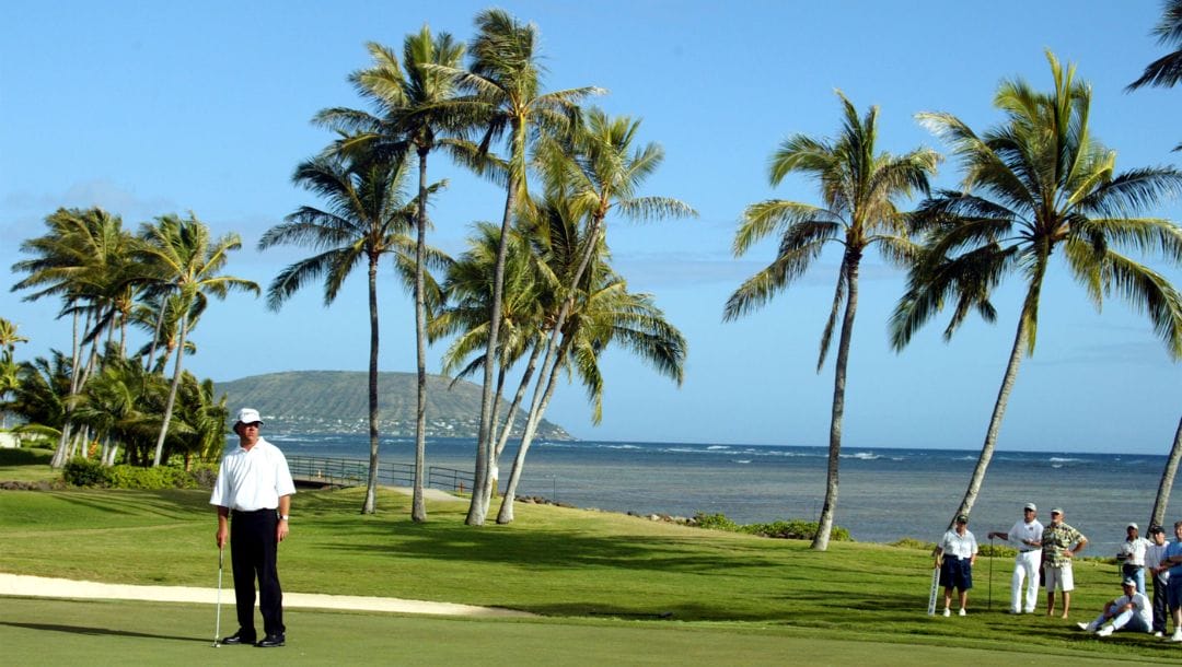 Andrew Magee of Paradise Valley, Az., stands on the scenic 17th green at Waialae Country Club and watches his putt for birdie.