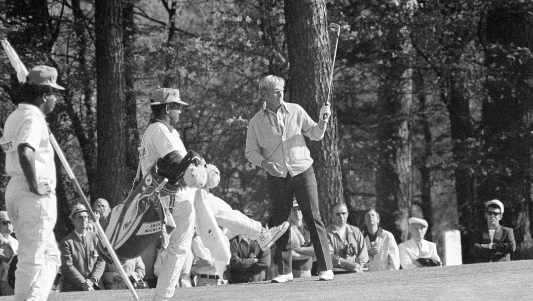 Jack Nicklaus throws up his putter as his caddie, Willie Peterson, kicks urging the ball on at Augusta, Ga., April 9, 1972, during the Masters golf tournament. It was 50 years ago when Nicklaus won his fourth green jacket.