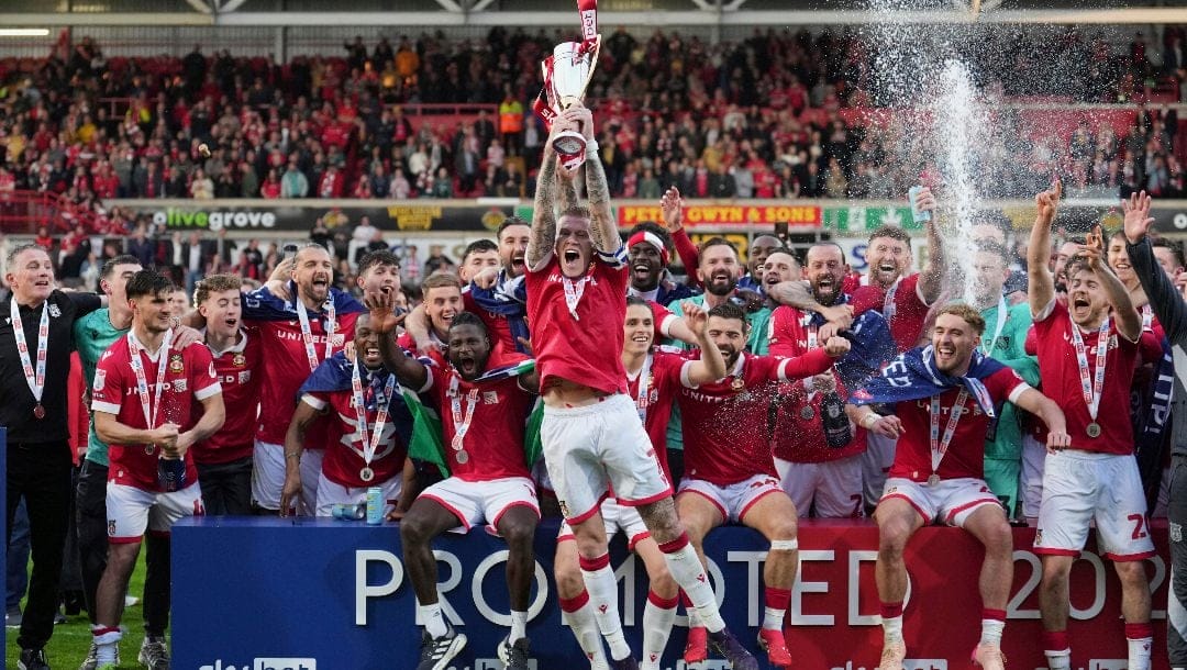 Wrexham's James McClean rises the trophy as they win the English League One soccer match between Wrexham and Charlton Athletic at the Racecourse ground in Wrexham, Wales, Saturday, April 26, 2025.