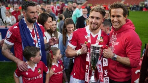Wrexham co-owner Ryan Reynolds, right, and Wrexham's Sam Smith pose with trophy at the end of the English League One soccer match between Wrexham and Charlton Athletic at the Racecourse ground in Wrexham, Wales, Saturday, April 26, 2025.