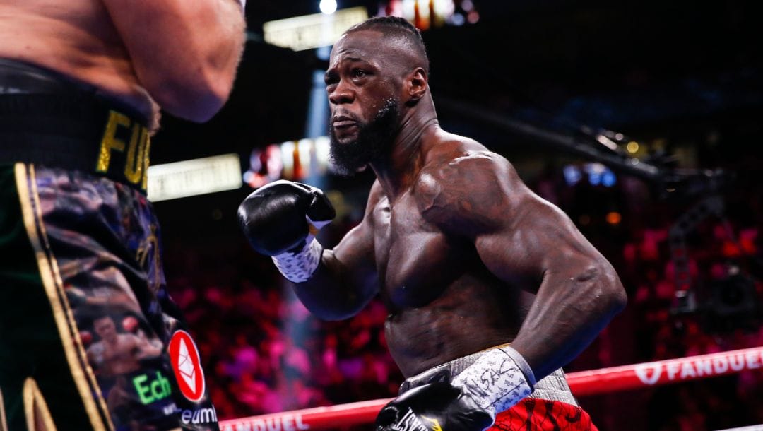Deontay Wilder, right, fights Tyson Fury, of England, in a heavyweight championship boxing match Saturday, Oct. 9, 2021.