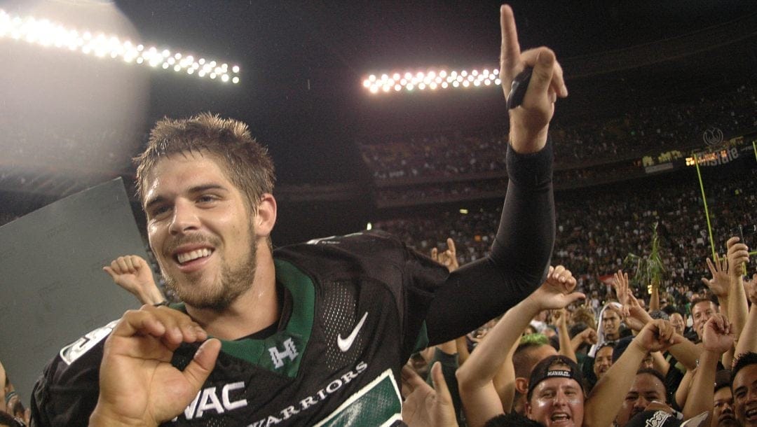 In this Nov. 23, 2007, file photo, then-Hawaii quarterback Colt Brennan celebrates after an NCAA college football game in Honolulu.