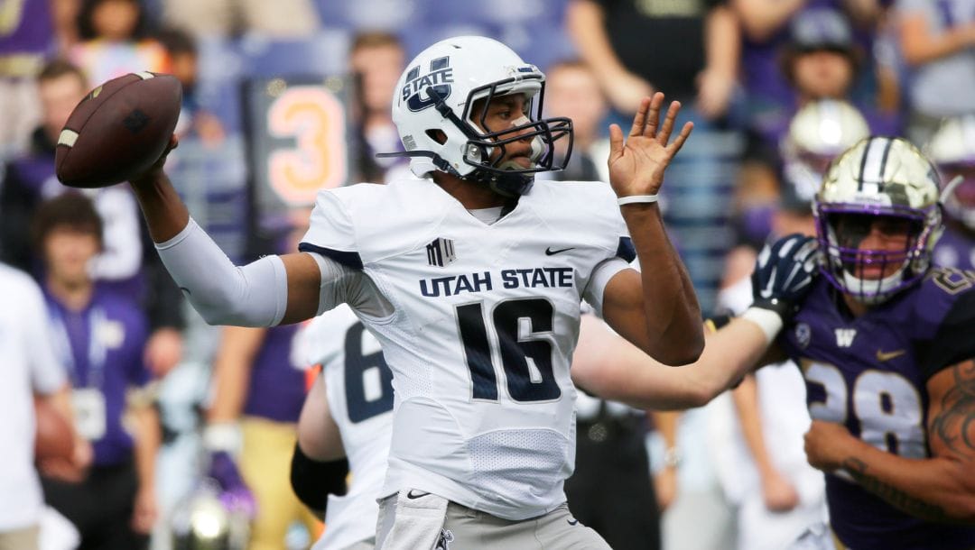 Utah State quarterback Chuckie Keeton passes against Washington in the first half of an NCAA college football game, Saturday.