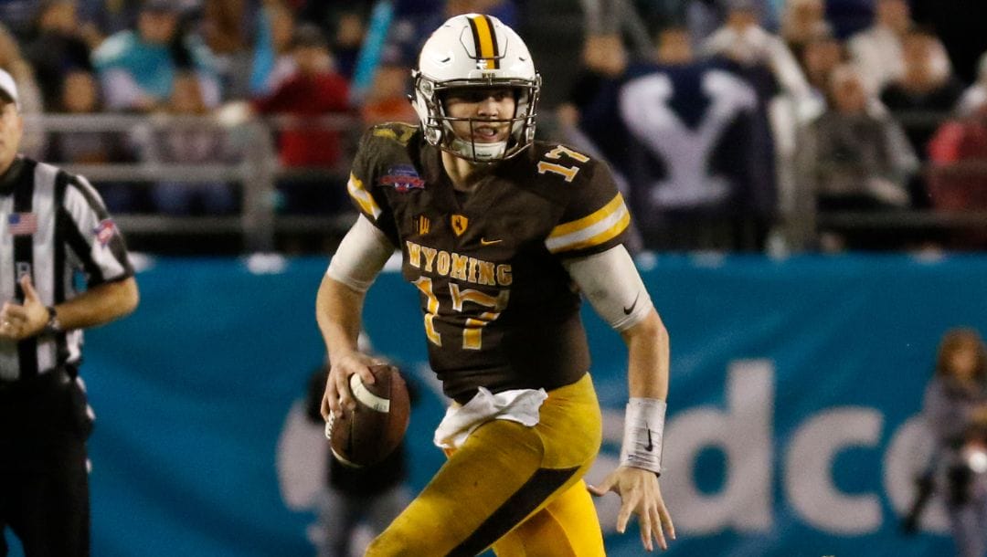 FILE - In this Dec. 21, 2016, file photo, Wyoming quarterback Josh Allen looks to throw against BYU during the second half.