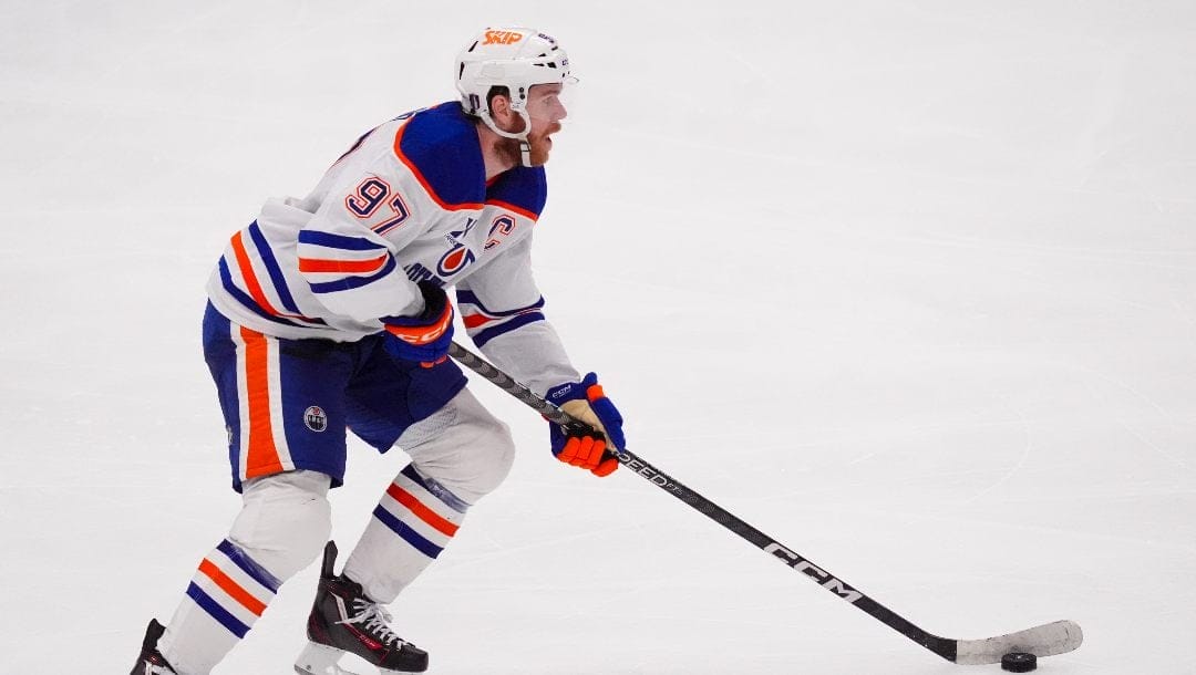 Edmonton Oilers center Connor McDavid skates with the puck against the Dallas Stars during the third period in Game 2 of the Western Conference finals in the NHL hockey Stanley Cup playoffs, Friday, May 23, 2025, in Dallas.