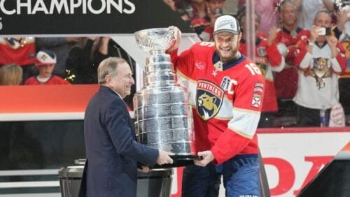 NHL commissioner Gary Bettman, left, hands the Stanley Cup to Florida Panthers captain Aleksander Barkov (16) after defeating the Edmonton Oilers in Game 6 of the NHL hockey Stanley Cup Final Tuesday, June 17, 2025, in Sunrise, Fla.