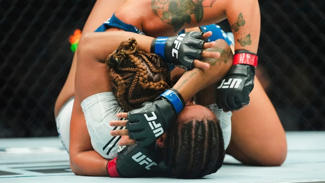 Argentina's Ailin Perez grapples with Panama's Joselyne Edwards, below, during the first round of a women's Bantamweight bout.