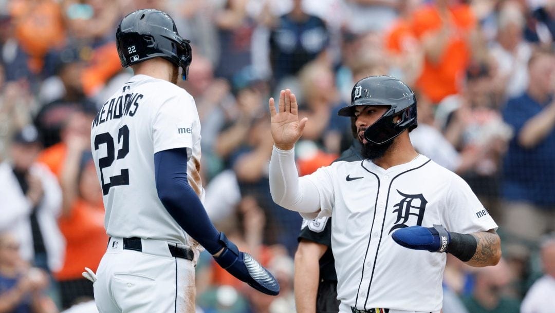 Detroit Tiger' Parker Meadows (22) celebrates with Gleyber Torres after they both scored against the Chicago Cubs on a double by Spencer Torkelson during the first inning of a baseball game Sunday, June 8, 2025, in Detroit.