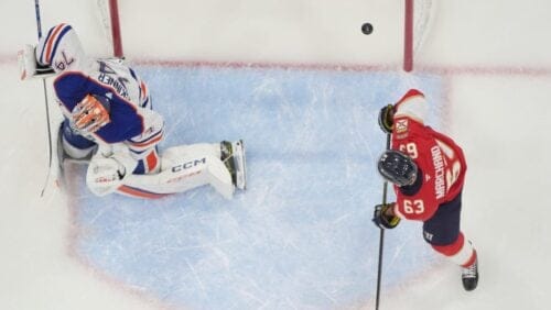 Florida Panthers center Brad Marchand (63) watches as a shot by center Carter Verhaeghe enters the goal against Edmonton Oilers goaltender Stuart Skinner (74) during the first period of Game 3 of the NHL Stanley Cup final Monday, June 9, 2025, in Sunrise, Fla.