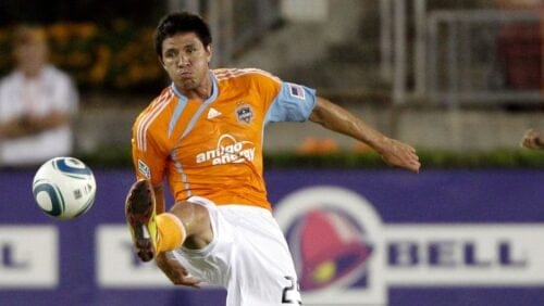 Houston Dynamo's Brian Ching (25) kicks the ball against the Philadelphia Union during the second half of an MLS soccer game.